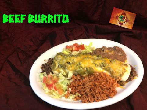 A beef burrito under green chile and cheese with Spanish rice, refried beans and shredded lettuce