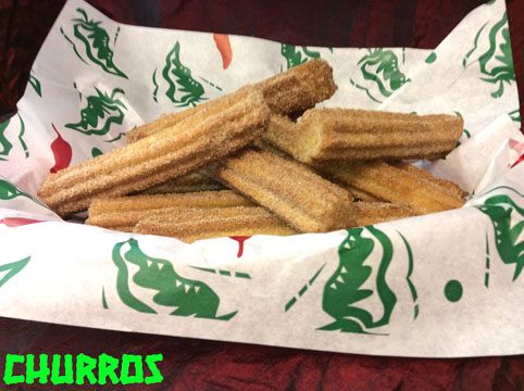 A basket of cinnamon sugar churros on chile-print paper