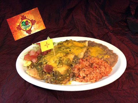 A plate of enchiladas under green chile and cheddar with Spanish rice, beans and lettuce