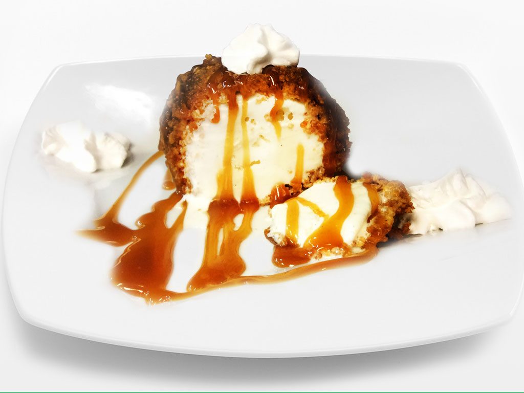 Fried ice cream with caramel drizzle and whipped cream